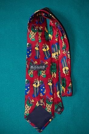 Red tie with colorful owl pattern on a teal background
