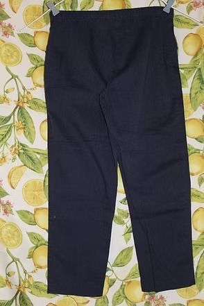 Dark navy pants laid flat on a patterned surface.