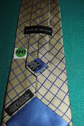Yellow tie with blue and brown diamond pattern on teal background