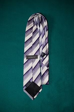 Striped necktie on a teal background.