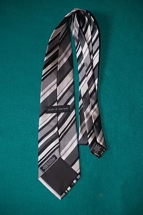 Black-and-silver striped necktie on a teal background
