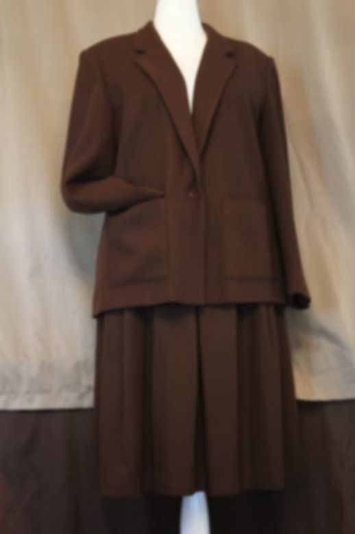 Brown tailored jacket and matching skirt displayed on a mannequin against a neutral backdrop