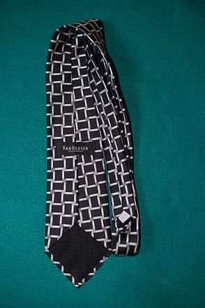 Black tie with a white geometric pattern on a green background