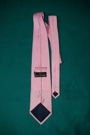 Pink necktie on a dark green background