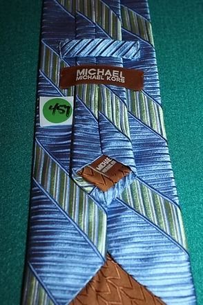 Blue striped necktie with diagonal green and purple stripes on a teal background