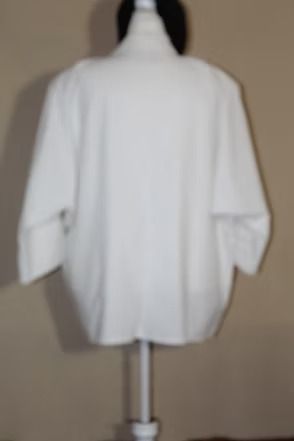 White long-sleeve robe jacket on a mannequin against a plain beige background
