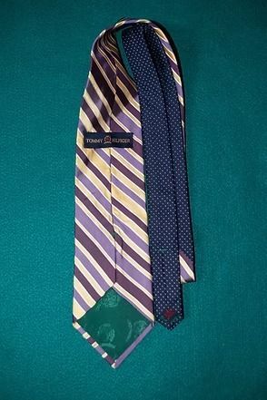 Purple and cream striped necktie on a teal background