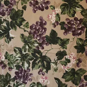Grape and ivy floral pattern on beige fabric with purple fruit and green leaves