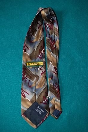 Patterned multicolor necktie on a teal background