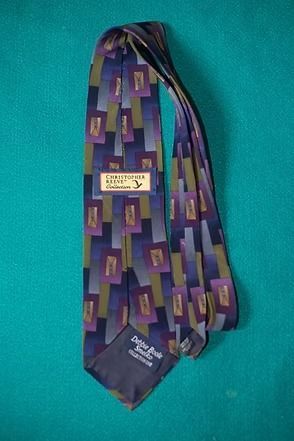 Purple geometric patterned necktie on a teal background