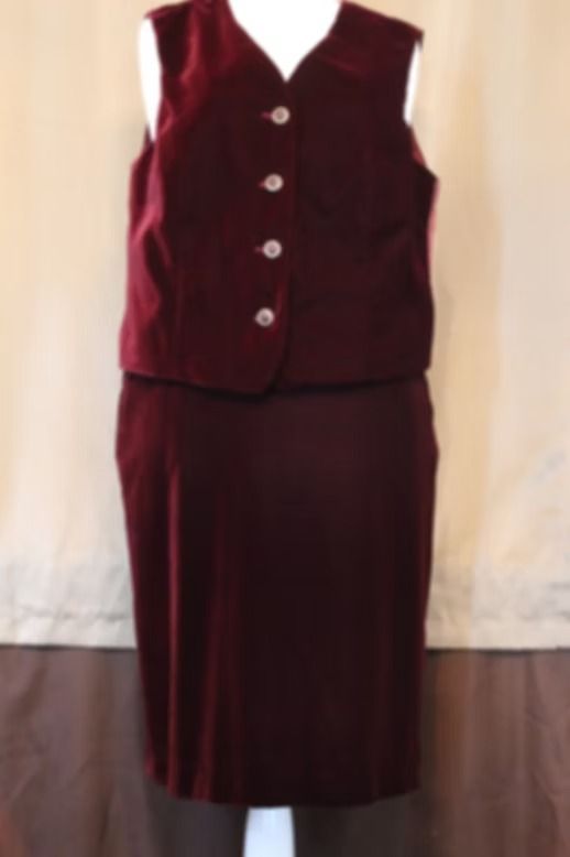 Maroon sleeveless vest and matching skirt displayed against a light backdrop