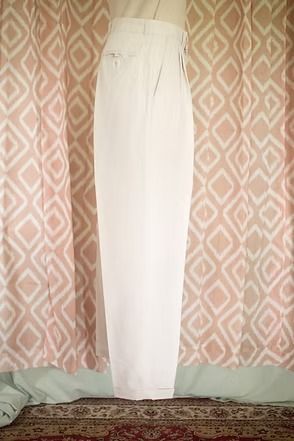 White curtains hanging in front of pink patterned drapes over a rug-covered floor