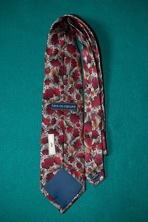 Red floral necktie on a teal background
