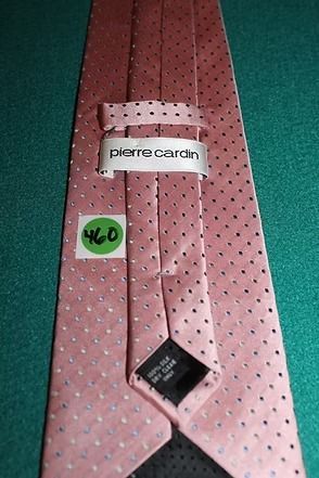 Pink polka dot necktie on a green background