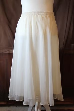 White sheer ankle-length skirt hanging against a dark background
