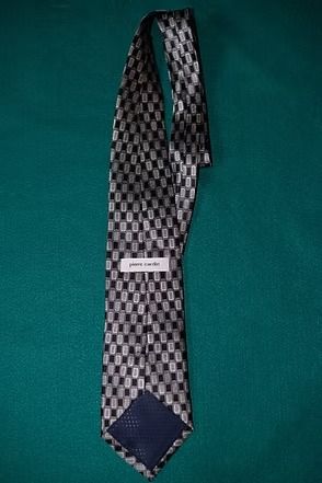 Black-and-white checkered necktie on a teal background