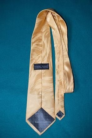 Beige necktie on a blue background
