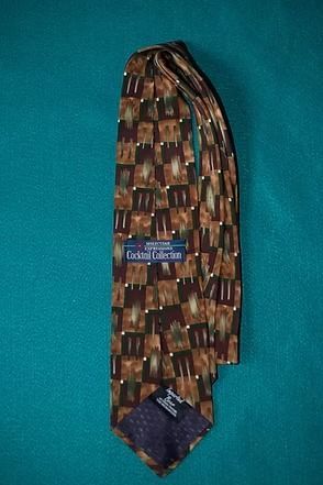 Patterned brown and tan necktie on a teal background