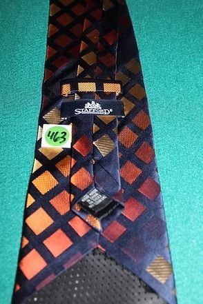 Red and orange diamond-pattern necktie on a teal background