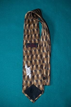 Brown patterned necktie on a teal background