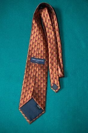 Copper patterned necktie on a teal background