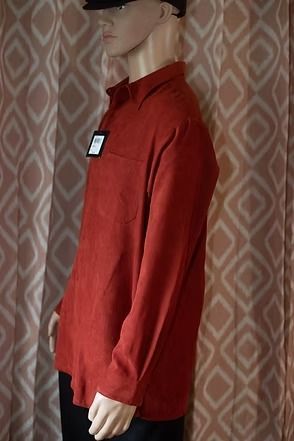 Mannequin wearing a red button-up shirt and black cap against a patterned backdrop