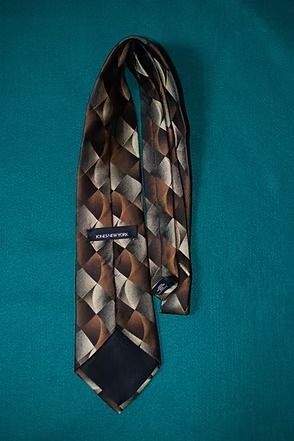 Brown patterned necktie on a teal background