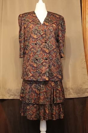 Patterned long-sleeve dress with a ruffled hem on a beige backdrop