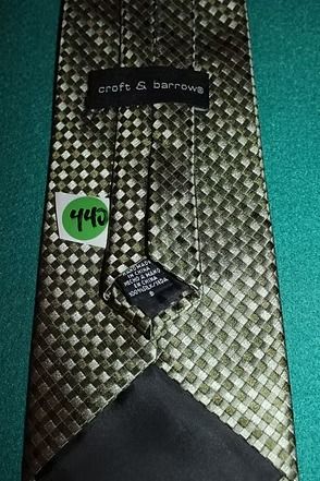 Black patterned necktie on a teal background