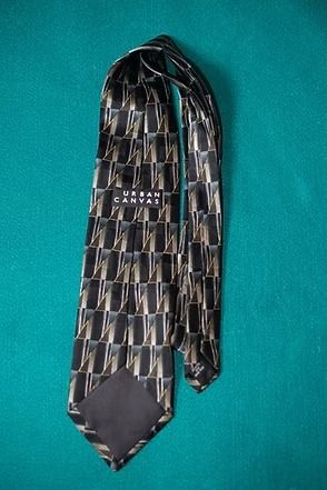Black-and-gray patterned necktie on a teal background