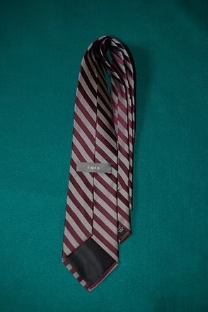 Red and white striped necktie on a teal background
