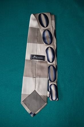 White tie with blue oval pattern on a teal background