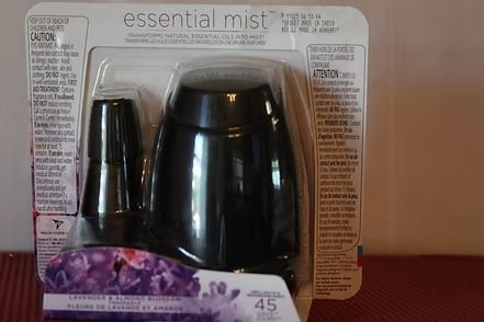 Air Wick Essential Mist diffuser box with lavender flowers and a black dispenser on a white background