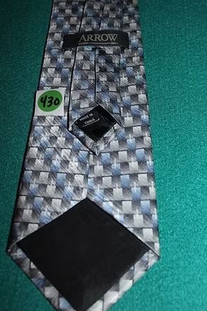 Patterned gray tie on a green background