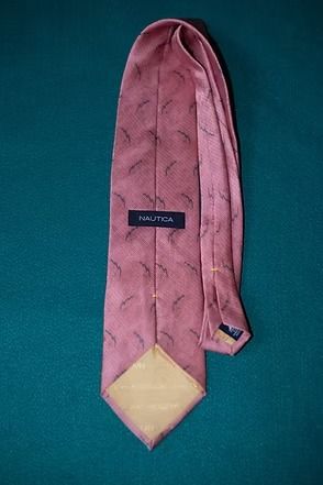 Pink patterned necktie on a teal background