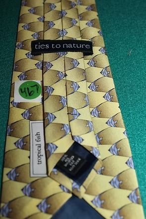 Yellow and blue patterned necktie on green fabric background