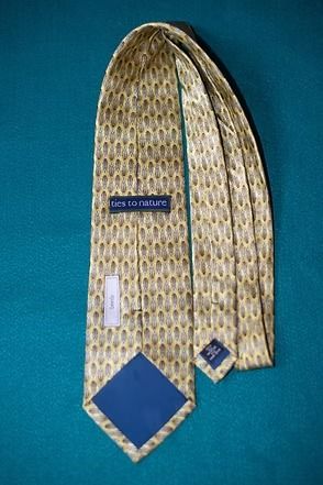 Beige patterned necktie on a blue background