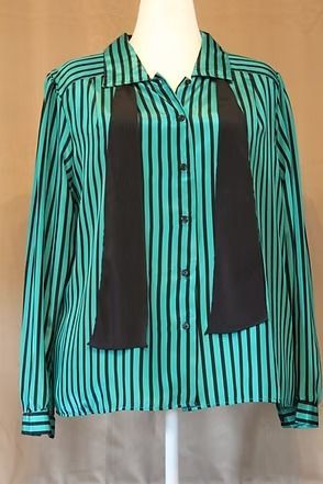 Striped teal and black long-sleeve button-up shirt with black front panels on a mannequin