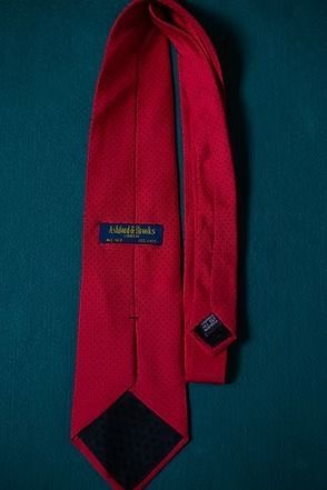 Red necktie on a teal background