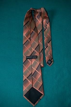 Pink and gray plaid necktie on a teal background