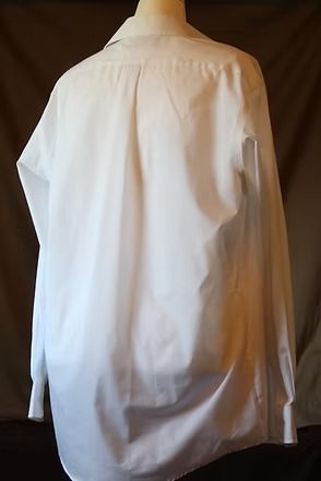 White button-up shirt with a large sleeve cutout, displayed on a mannequin against a dark background