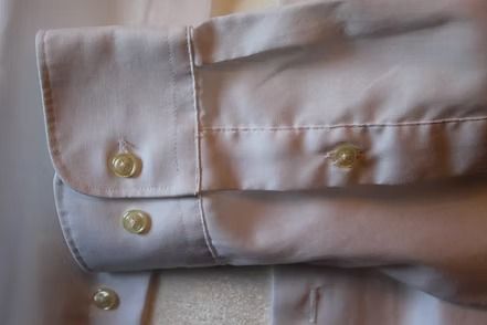 White long-sleeve button-down shirt with a chest pocket on a mannequin
