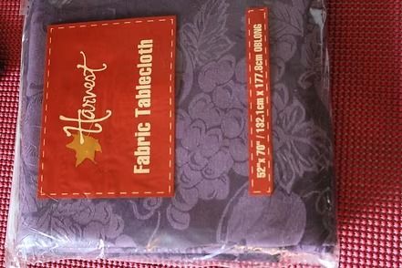 Packaged Harvest purple floral fabric tablecloth with red label