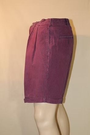 Maroon shorts on a mannequin against a plain beige background
