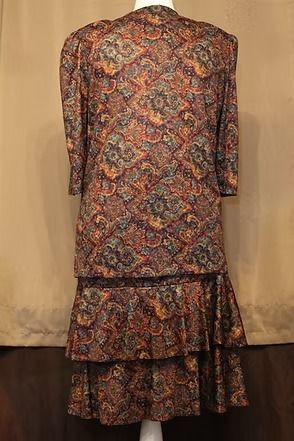 Patterned long-sleeve dress with a ruffled hem on a beige backdrop