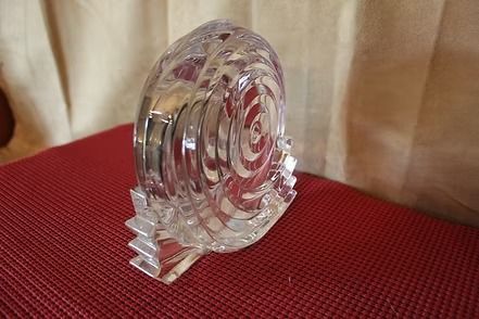 Glass desk clock on a red textured surface
