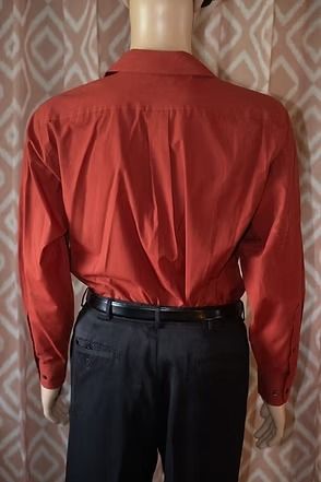 Close-up of a red Stafford garment label with black tags on textured fabric.