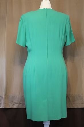 Green short-sleeve dress on a mannequin, shown from the back.