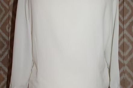 White blouse with ornate gold floral embroidery on the collar and buttons