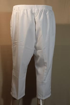 White pants hanging on a hanger against a plain background